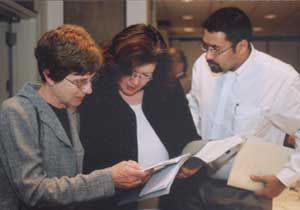 Photo: (Left to right) Advocacy Day attendees Mary Pauly, MD; Natalie Bzowej, MD, PhD; and Vivek Huilgol, MD, make final preparations before meeting with their Congressional offices.